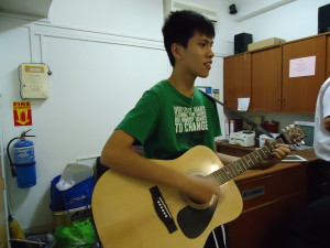 High School youth playing the guitar